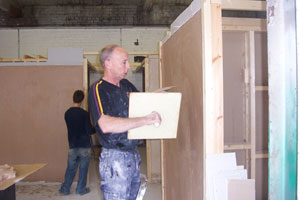 Cutting plasterboard to size, fixing boards to ceilings, walls and corners
